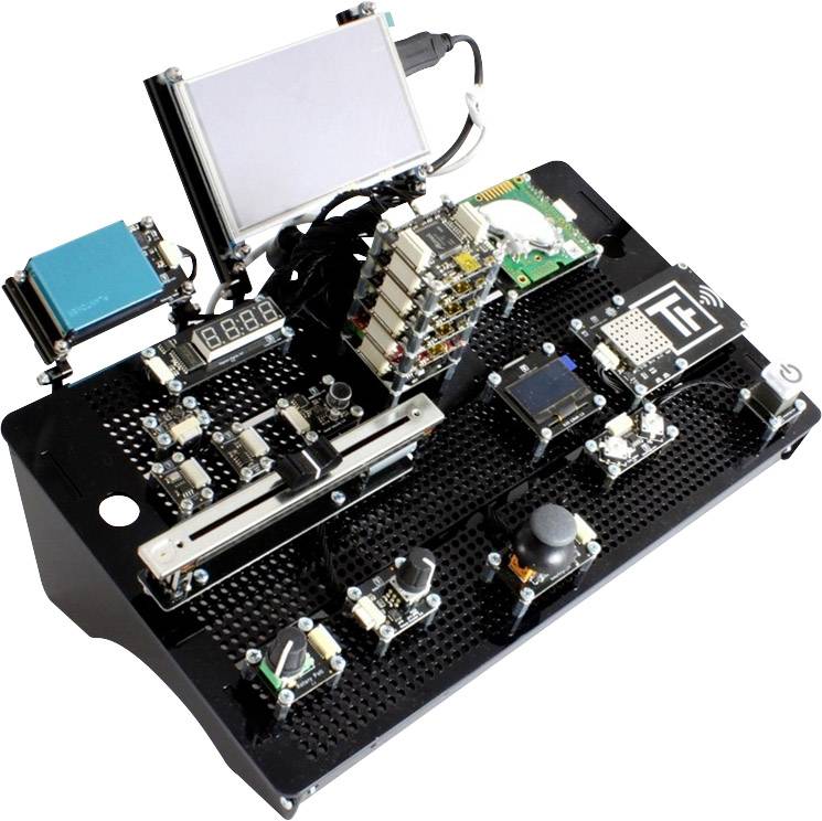 Kit de développement électronique multimodulaire avec plusieurs modules, capteurs et éléments d'affichage sur une carte de circuit imprimé noire.