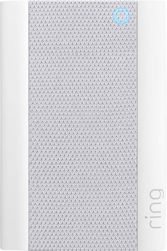 Un appareil intelligent, rectangulaire, avec un bord blanc et une grille de haut-parleur grise. Un petit anneau bleu s'allume en haut à droite.