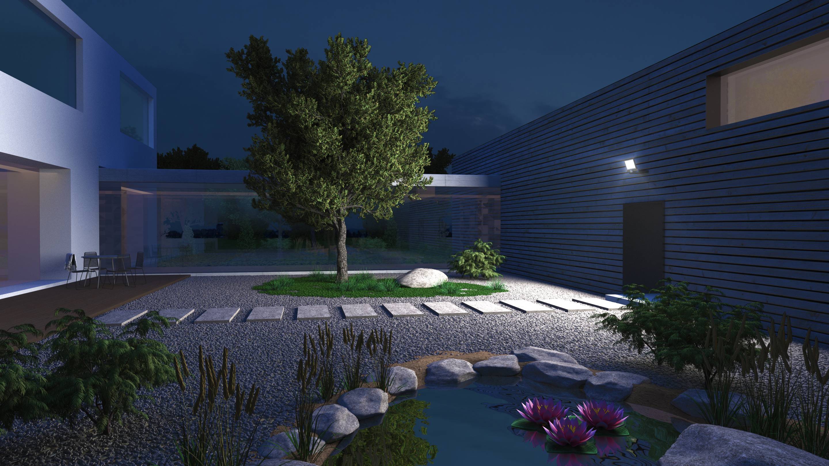Une cour intérieure moderne la nuit, éclairée, avec un arbre au centre et un petit étang rempli de nénuphars au premier plan.
