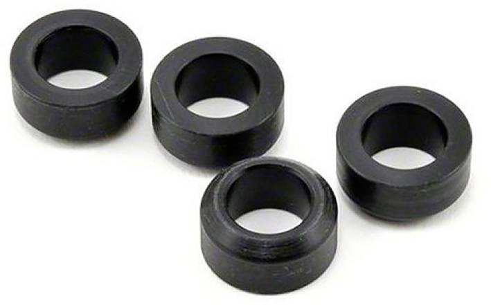 Quatre rondelles noires, rondes et en plastique sur un fond blanc, vues de dessus.