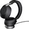 Écouteurs noirs sans fil, de type over-ear, posés sur un chargeur. Ils ont un design moderne et ergonomique, adaptés pour écouter de la musique ou passer des appels.
