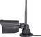 Une caméra de surveillance noire avec antenne, montée sur le côté, avec connexion par câble à la base.
