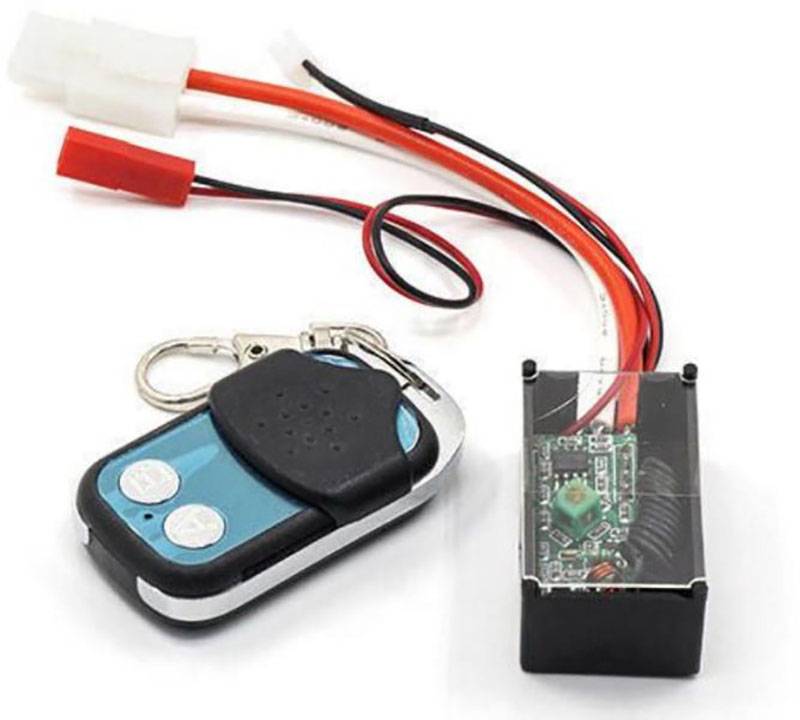 Ensemble de télécommande avec récepteur électronique et connexion filaire en noir, rouge et blanc sur fond blanc.