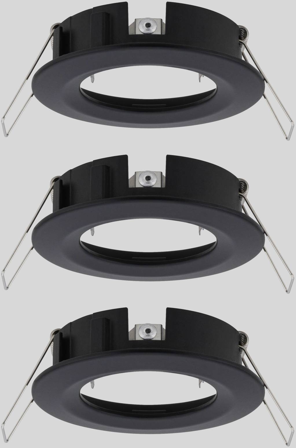 Trois cadres d'encastrement ronds noirs pour spots de plafond. Chaque cadre est équipé de deux pinces latérales pour la fixation.