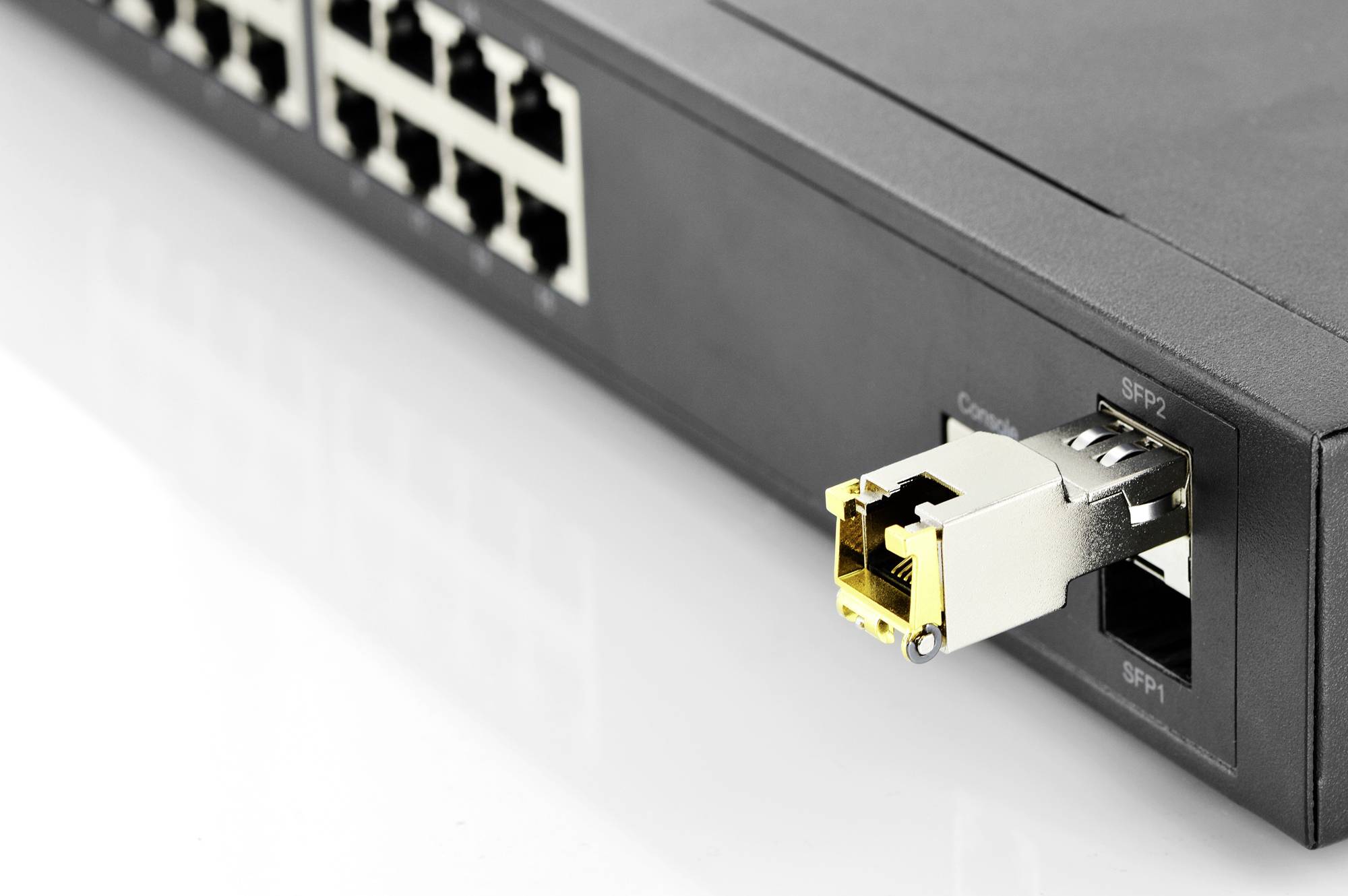 Un commutateur réseau doté de plusieurs ports Ethernet et d'un module SFP inséré dans l'un de ses ports SFP.