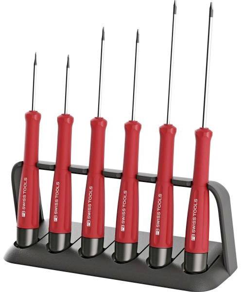 Six tournevis rouges avec des embouts noirs, rangés verticalement dans un support noir.