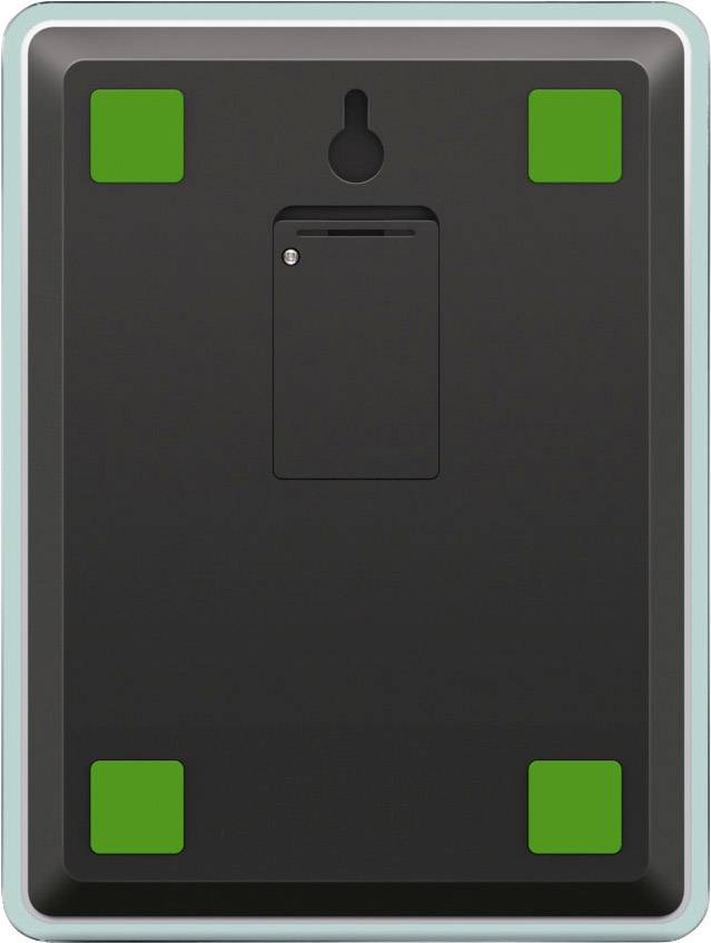 Verso d'un appareil électronique avec quatre pieds en caoutchouc vert aux angles et une fine fente au centre.