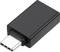 Adaptateur USB-C noir en gros plan, posé à plat, montrant le côté des connecteurs en premier plan.