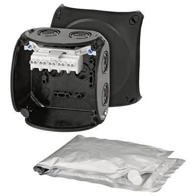 Boîte de distribution électrique noire avec couvercle ouvert, les bornes de connexion sont visibles. Un sachet non ouvert est posé en dessous.