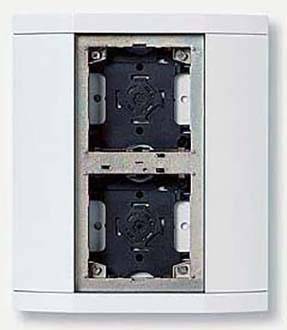 Deux cadres de prises électriques noirs vides dans un support blanc, préparés pour des branchements électriques.