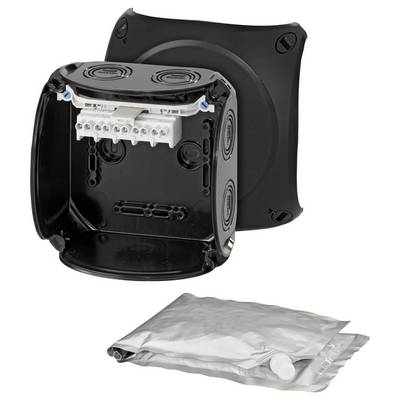 Boîte en plastique noir avec des côtés ouverts, comportant des bornes de connexion blanches à l'intérieur. À côté, un sac en plastique argenté fermé.