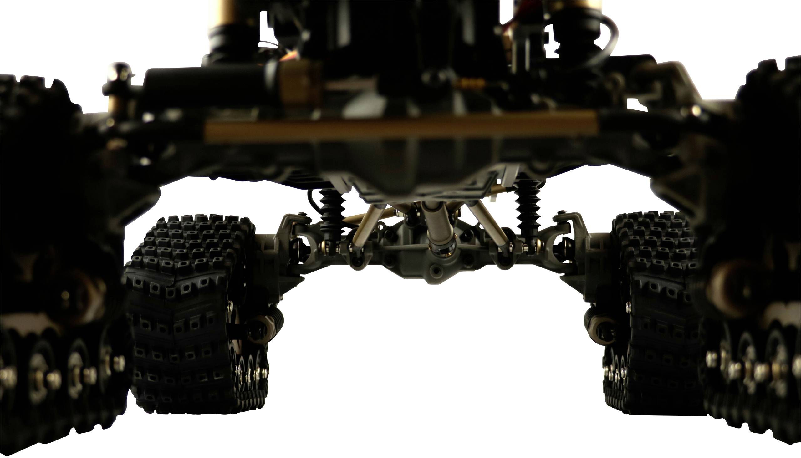 Gros plan d'un véhicule tout-terrain télécommandé avec de grandes roues à profil prononcé et suspension visible. Vue de dessus sur fond neutre.