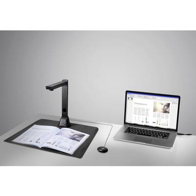 Un scanner de documents numérise un livre ouvert. À côté, un ordinateur portable dont l'écran affiche le contenu numérisé du livre.
