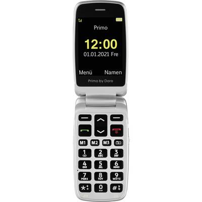 Un téléphone portable à clapet avec de grandes touches. L'écran affiche 'Primo', la date '01.01.2021', l'heure '12:00' et des symboles bien distincts.