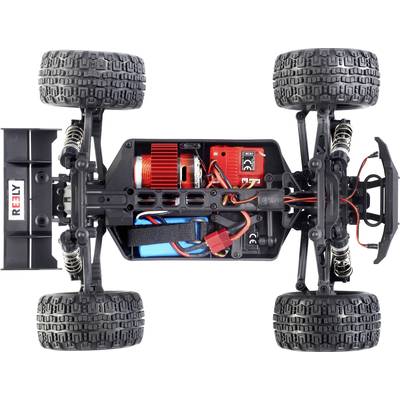 Vue de dessus d'une voiture télécommandée sans carrosserie, montrant des composants internes tels que le moteur électrique, les batteries et les câbles.