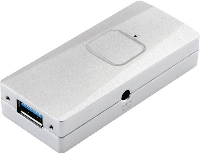 Un périphérique électronique rectangulaire argenté avec un port USB ; probablement un adaptateur ou un chargeur.