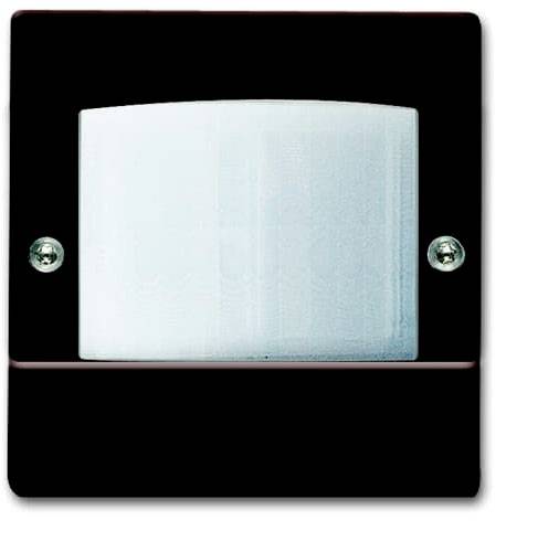 Un capteur rectangulaire blanc sur fond noir, monté sur un mur. Deux vis sont visibles.