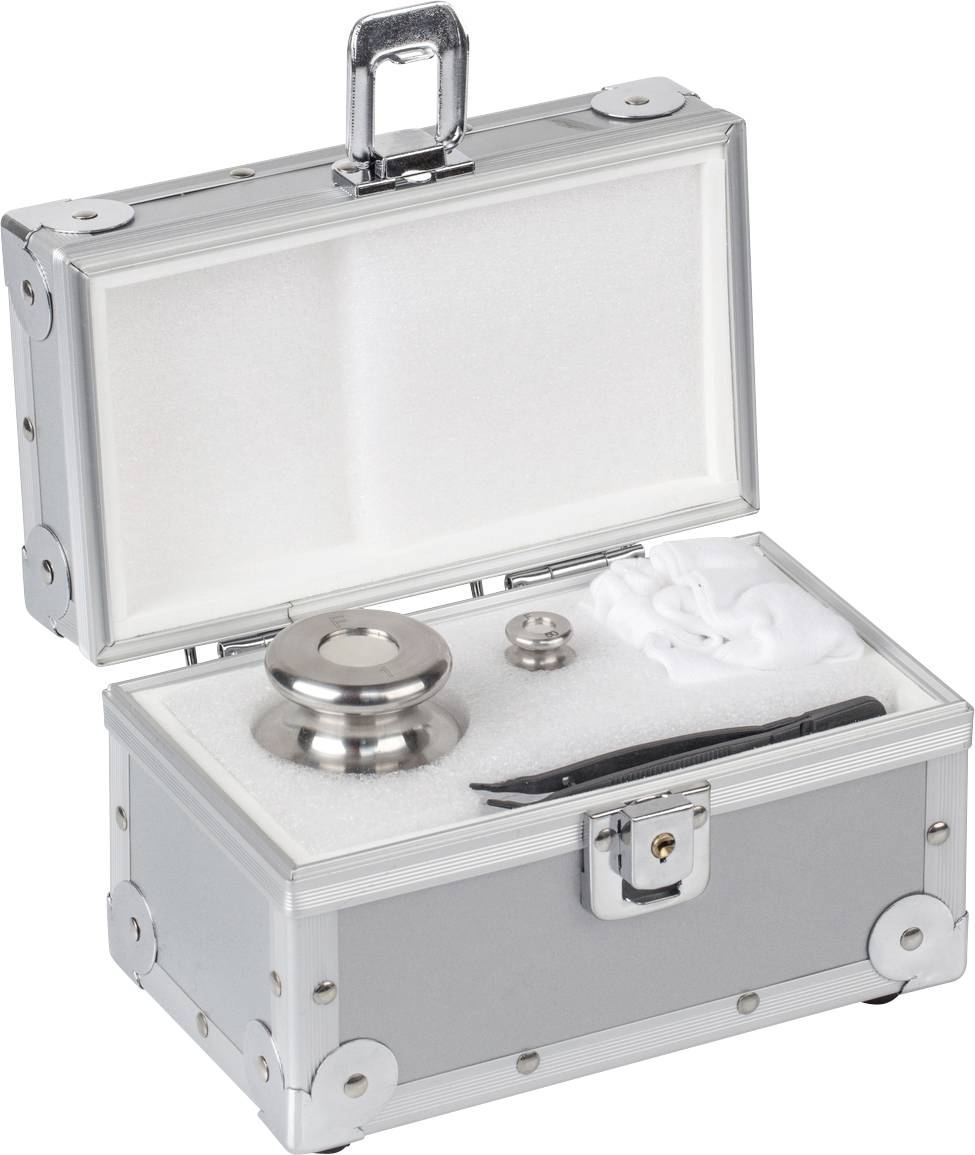 Valise argentée, ouverte, montrant à l'intérieur un ensemble de poids de calibrage comprenant différents poids métalliques et accessoires.