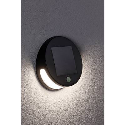 Luminaire extérieur moderne et rond avec panneau solaire intégré, fixé à un mur. Idéal pour un éclairage de jardin économe en énergie.