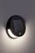 Luminaire extérieur moderne et rond avec panneau solaire intégré, fixé à un mur. Idéal pour un éclairage de jardin économe en énergie.