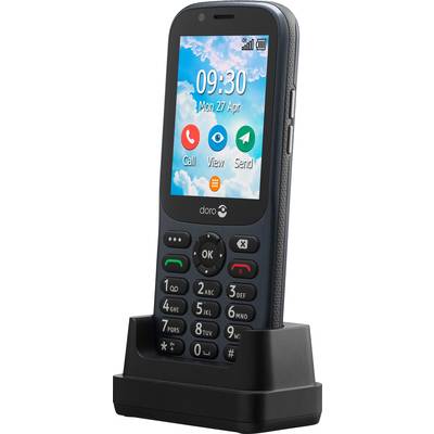 Un téléphone portable à touches, posé sur un chargeur. L'écran affiche l'heure 09:30 et la date lundi 27 avril.