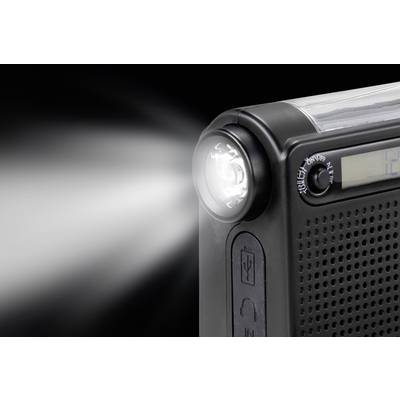Une radio portable noire avec une lampe de poche intégrée s'illumine vivement. Un nombre est partiellement visible sur un écran.