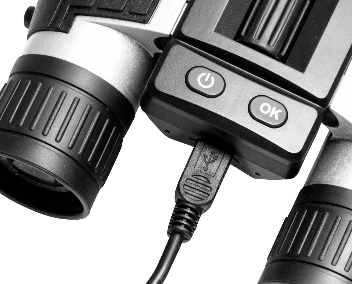 Gros plan d'un appareil électronique avec un port USB, deux objectifs et des boutons de commande portant les symboles 'Power' et 'OK'.