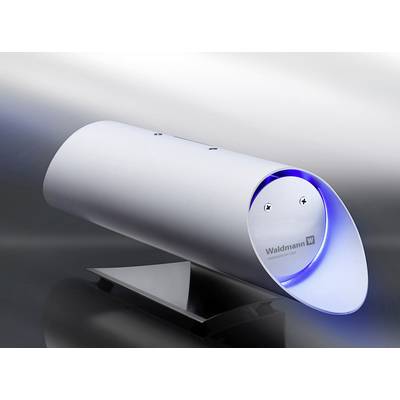 Un dispositif futuriste argenté avec une lumière bleue à l'intérieur. Il est posé sur un socle noir et porte l'inscription 'Waldmann'.
