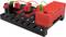 Kit d'apprentissage électronique avec un composant rouge et noir sur une base noire. Différents modules sont câblés et interconnectés.
