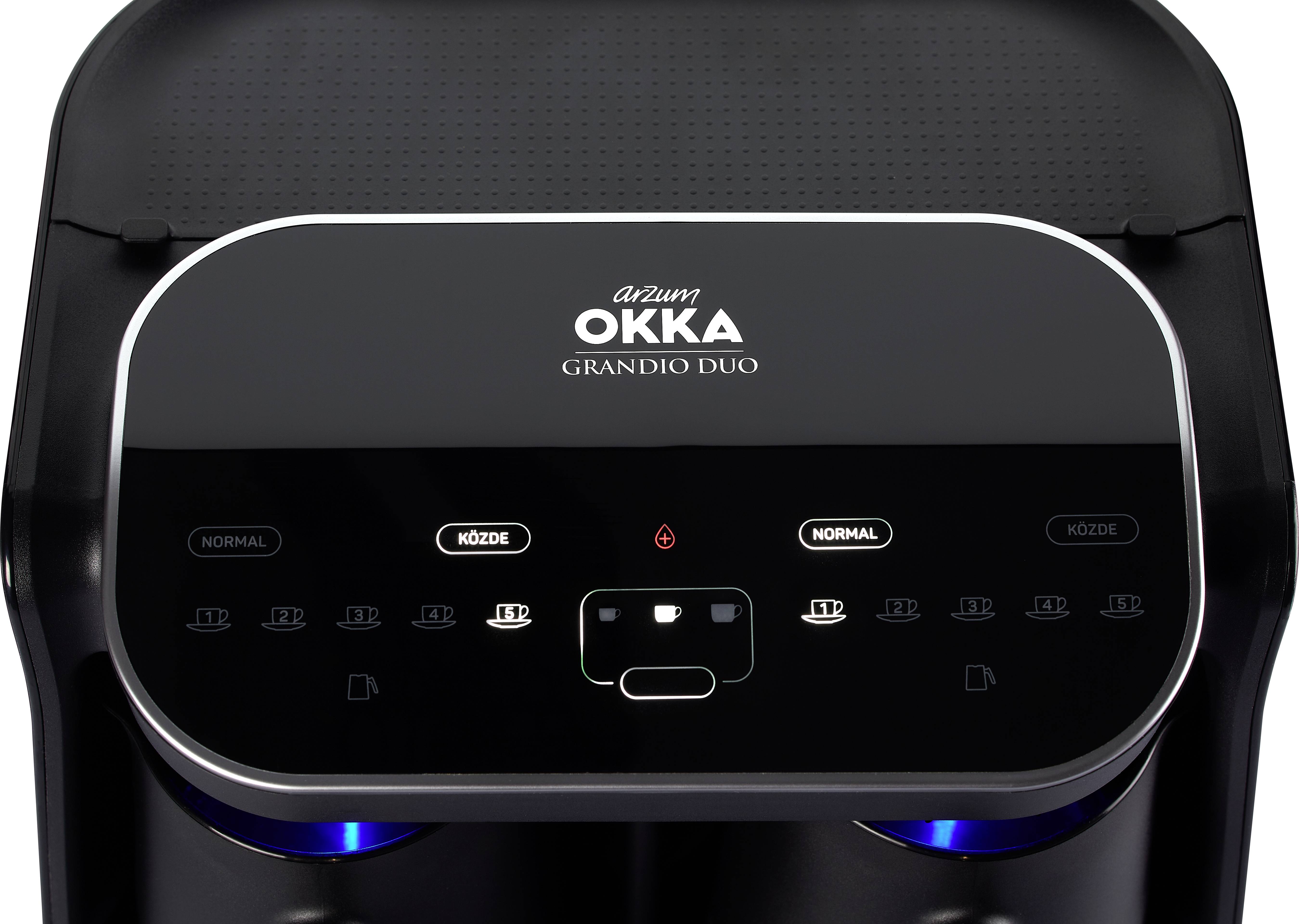 Machine à café avec panneau de commande numérique, le nom de marque 'Arzum Okka' est visible ; des symboles éclairés indiquent les options et réglages de café.