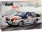 Un kit de maquette montre une voiture de rallye Audi Quattro sur un parcours enneigé. Marquages de marque emblématiques et numéro de course 5.