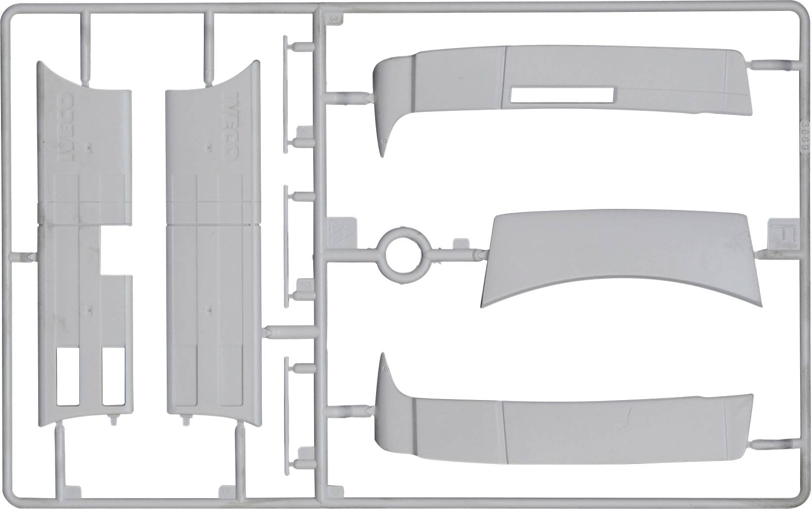 Kit de modélisme en plastique gris composé de quatre pièces emboîtables dans un cadre grillagé. Les pièces sont prévues pour la construction d'un modèle.