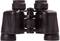 Une paire de jumelles noires avec deux oculaires et une molette centrale de mise au point, posée sur une surface blanche.