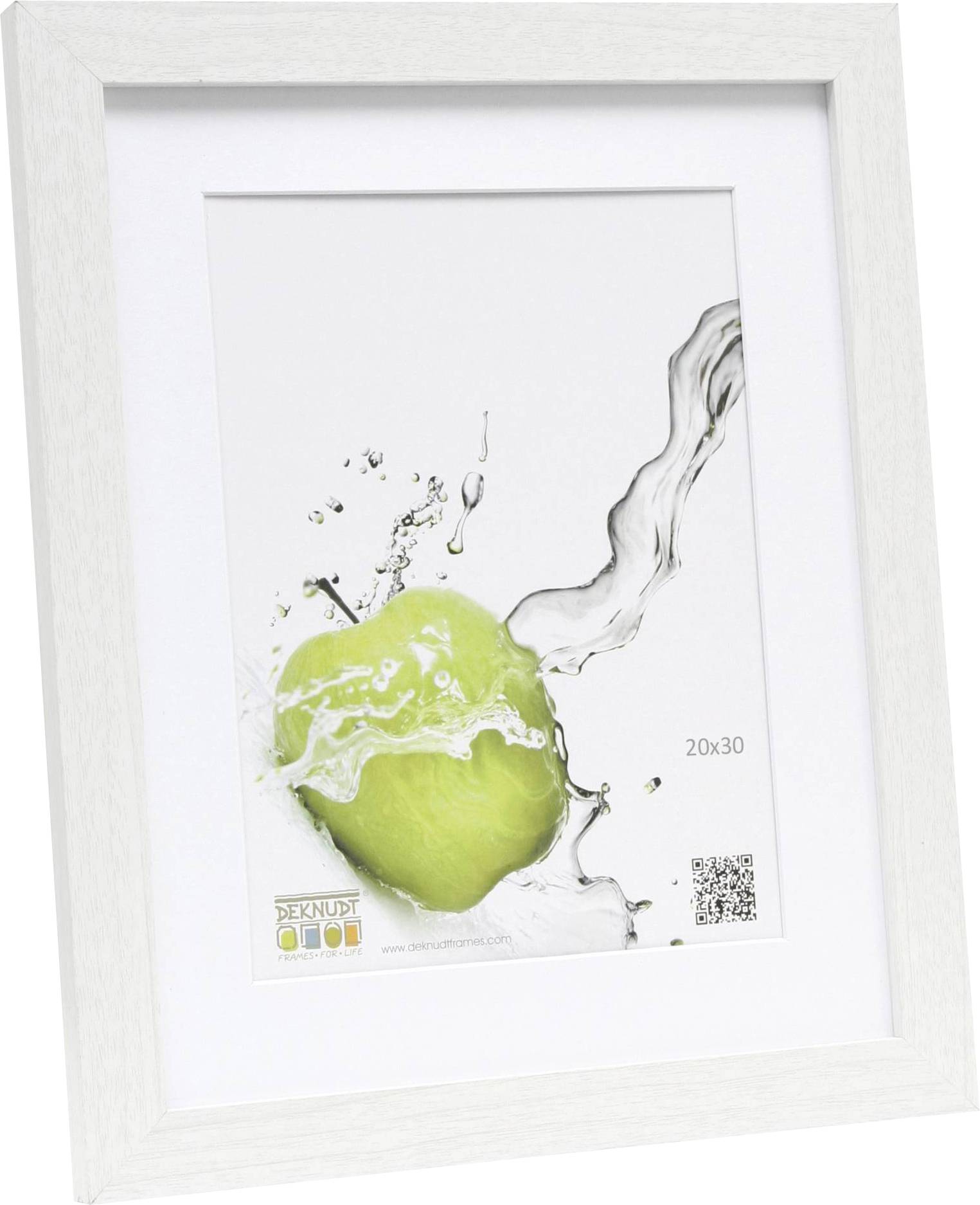Un cadre blanc encadre une image montrant une pomme verte touchée par un éclaboussement d'eau. Dimensions : 20x30 cm.