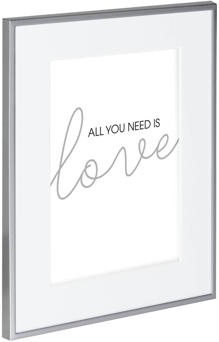 Inscription dans un cadre photo avec le texte « Tout ce dont tu as besoin, c'est l'amour »