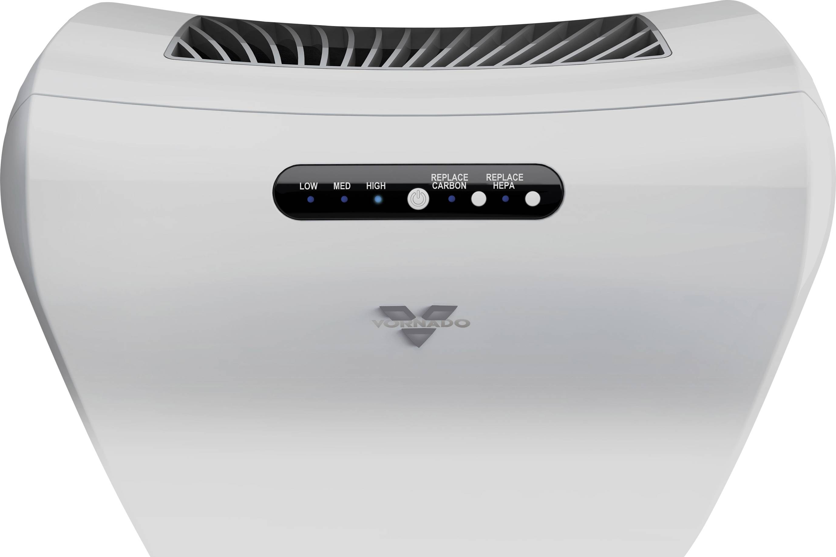 Purificateur d'air avec indicateur de trois niveaux de performance et boutons pour changer le filtre à charbon et le filtre HEPA, marqué 'Vornado'.