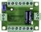 Circuit imprimé vert avec plusieurs bornes à vis, un potentiomètre bleu et un condensateur noir.