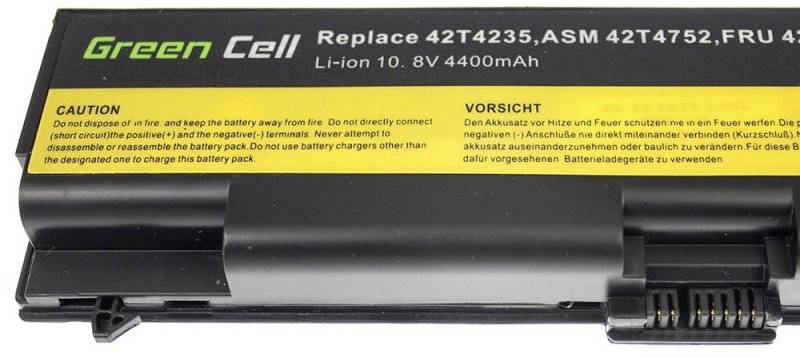 Une batterie d'ordinateur portable avec l'inscription 'Green Cell'. Informations sur les numéros de pièce de rechange, la tension (10,8V), la capacité (4400mAh) et les avertissements.