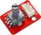Module d'encodeur rotatif avec carte de circuit imprimé rouge et connecteur blanc. Le bouton rotatif est visible à gauche, et le connecteur de raccordement est situé au centre.