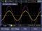 Image d'oscilloscope avec deux ondes sinusoïdales superposées, jaune et violette. Affiche des mesures de tension et de temps, avec l'amplitude et la fréquence.