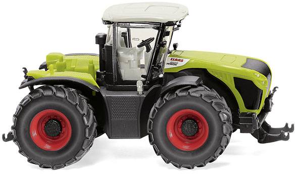 Un tracteur de jouet vert avec quatre grandes roues et un toit blanc.