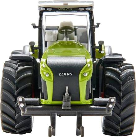 Tracteur vert de la marque Claas vu de face, avec de grandes roues et un toit blanc. Le nom du modèle 'Xerion' est inscrit en haut du pare-brise.
