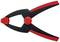 Serre-joints noirs et rouges avec des poignées courbées et un pivot central rond, adaptés pour maintenir ou serrer des objets.
