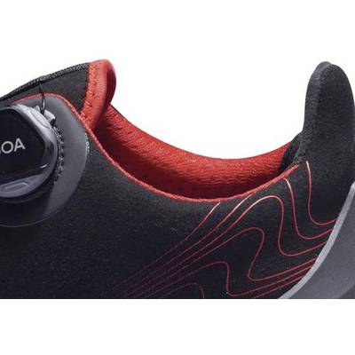 Chaussure de sport noire et rouge avec fermeture à rotation et lignes rouges courbes sur le côté.