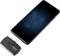 Un smartphone à l'écran sombre est posé à côté d'un adaptateur COM de VOLTCRAFT. L'adaptateur dispose d'un port USB-C.