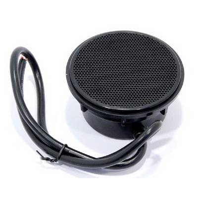 Un haut-parleur rond noir, relié par un câble, est posé sur une surface blanche.