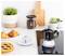 Un cafetière à espresso de style moka sur un comptoir de cuisine, accompagnée d'une tasse de café, des croissants, une tarte et un bocal de café, créant un cadre de petit-déjeuner chaleureux et accueillant.