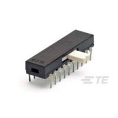 Un circuit intégré électronique noir avec plusieurs broches métalliques, posé sur une surface blanche.