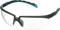 Lunettes de protection avec verres transparents, monture gris foncé avec détails turquoise. Idéales pour la sécurité au travail ou les activités sportives.