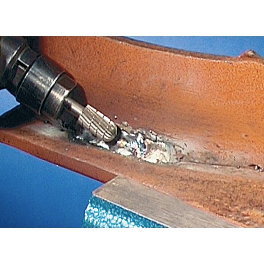 Gros plan d'une machine enlevant de la rouille d'une surface métallique.